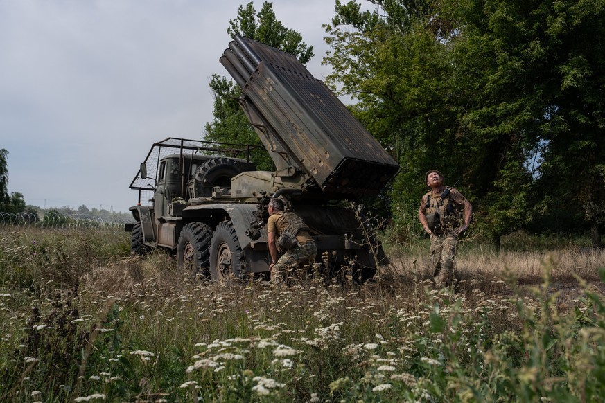 In this photo provided by Ukraine's 93rd Kholodnyi Yar Separate Mechanized Brigade press service, soldiers prepare an MRLS BM-21 "Grad" to fire at Russian positions near the frontline c ...
