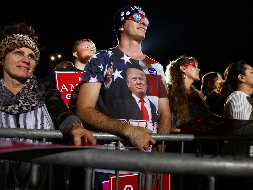 Supporters of Republican presidential candidate Donald Trump listen as he speaks during a campaign rally in October in Cedar Rapids, Iowa.