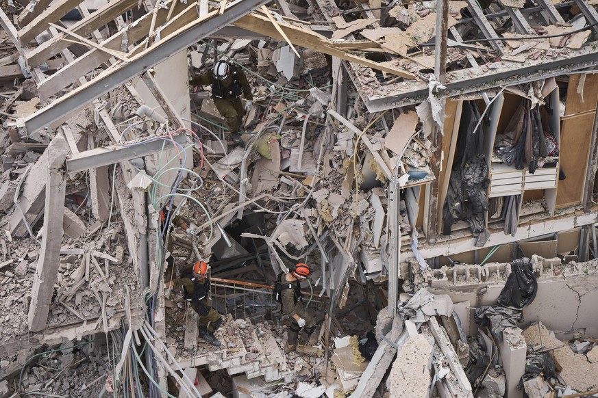 Rescue workers and security forces work at the site of a direct missile strike launched from Iran in Tel Aviv, Israel, on Sunday, June 22, 2025. (AP Photo/Oded Balilty)
Israel Iran Mideast Wars