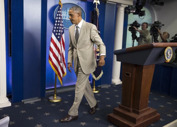 President Barack Obama leaves the James Brady Press Briefing Room of the White House in Washington, Thursday, Aug. 28, 2014, after speaking about the economy, Iraq, and Ukraine, before convening a mee ...