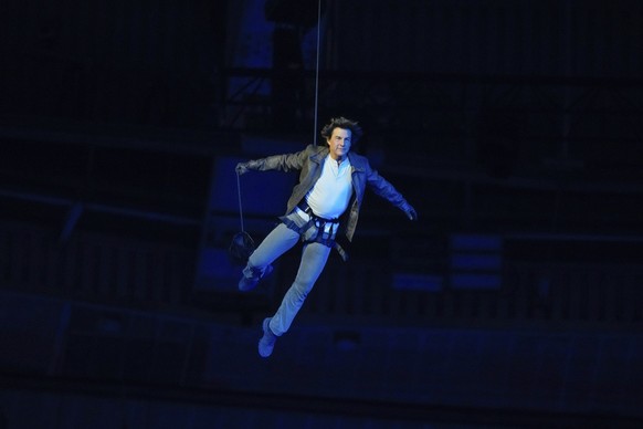 Tom Cruise is lowered on the State de France during the 2024 Summer Olympics closing ceremony, Sunday, Aug. 11, 2024, in Saint-Denis, France. (AP Photo/Natacha Pisarenko)