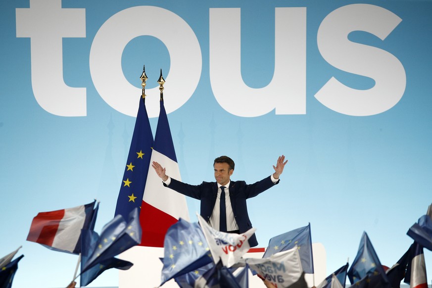 epa09883470 French President and candidate for re-election Emmanuel Macron reacts after results in the first round of the French presidential elections in Paris, France, 10 April 2022. According to in ...