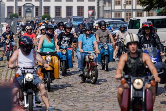 Participants ride Simson mopeds during an election campaign event of the far-right Alternative for Germany (AfD) party's and a motorbike and moped ride in Oranienbaum, eastern Germany on June 28, ...