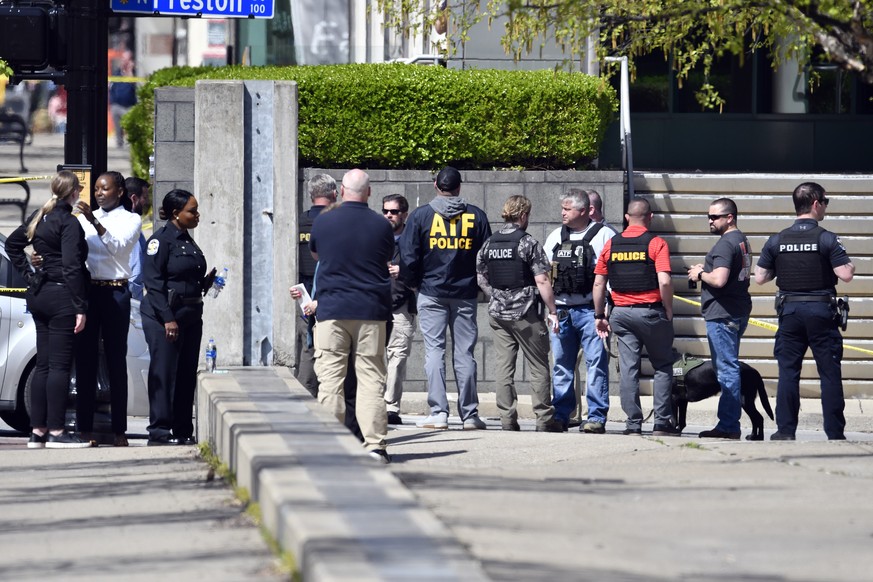 Members of theLouisville Metro Police and federal ATF agents gather outside of the Old National Bank building in Louisville, Ky., Monday, April 10, 2023. A shooting at the bank killed and wounded seve ...