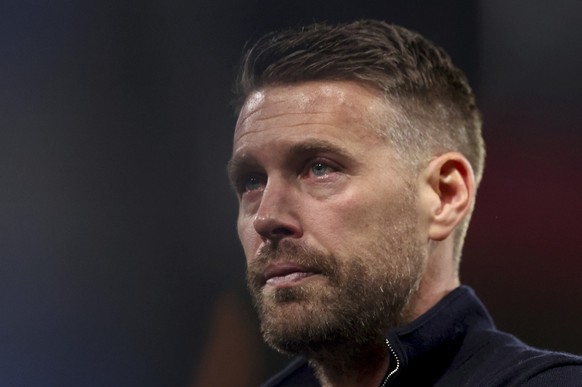 Luton Town manager Rob Edwards reacts as he makes his way around the stadium after the game was abandoned following the collapse of their team mate Tom Lockyer, during the English Premier League socce ...