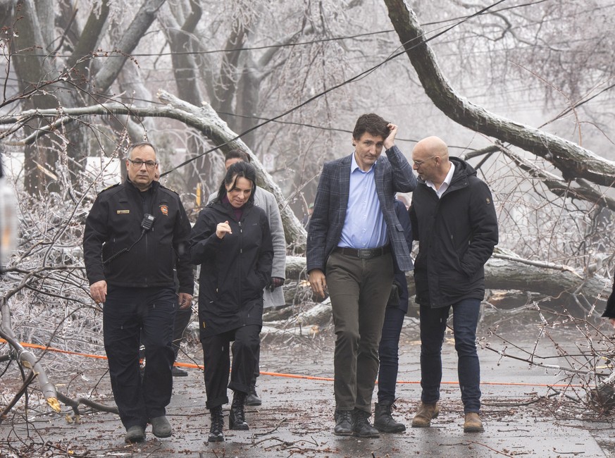 Prime Minister Justin Trudeau and Mayor Valerie Plante look at the damage after yesterday&#039;s ice storm, which left over a million customers without power, in Montreal, Thursday, April 6, 2023. (Ry ...