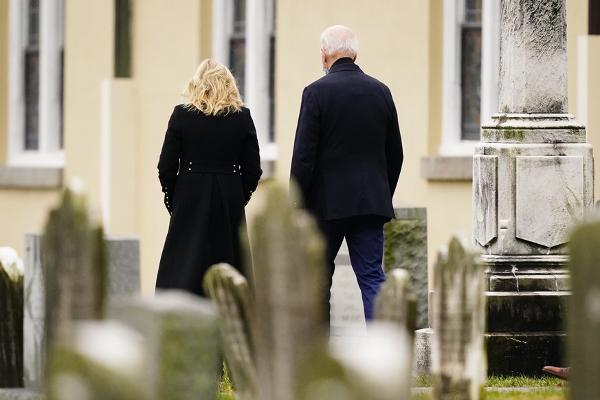 President Joe Biden and first lady Jill Biden walk from St. Joseph on the Brandywine Catholic Church in Wilmington, Del., Saturday, Dec. 18, 2021. (AP Photo/Matt Rourke)