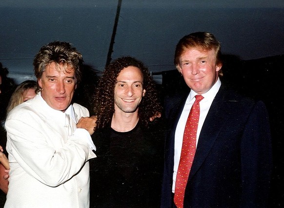 Group portrait of, from left, British musician Rod Stewart, American musician Kenny G (born Kenneth Gorelick), and businessman Donald Trump as they pose together at the Mar-a-Lago estate, Palm Beach,  ...