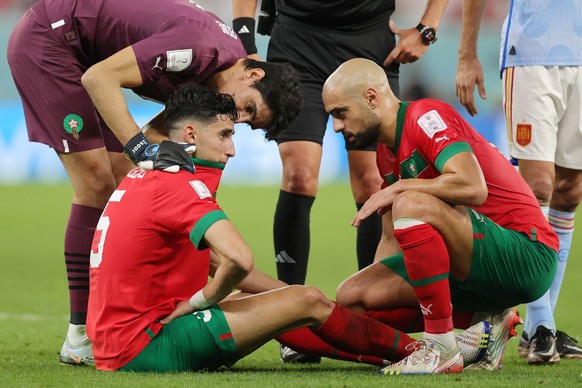 epa10352174 Nayef Aguerd (C) and Sofyan Amrabat (R) of Morocco react during the FIFA World Cup 2022 round of 16 soccer match between Morocco and Spain at Education City Stadium in Doha, Qatar, 06 Dece ...