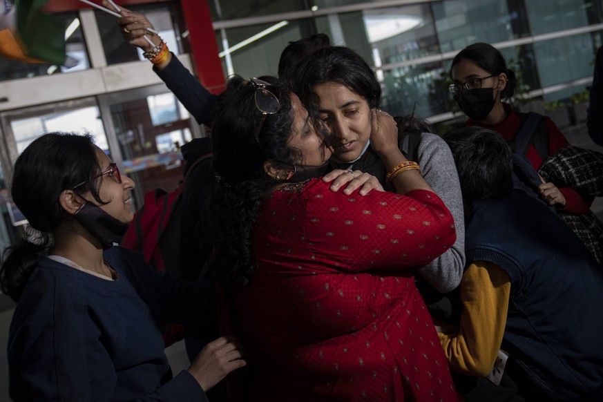 Mansi Singhal, an Indian student studying in Ukraine who fled the conflict, and her mother hug each other upon her arrival at Indira Gandhi International Airport in New Delhi, India, Wednesday, March  ...