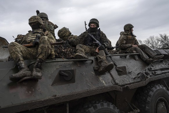 Ukrainian servicemen ride atop by an APC towards frontline positions near Vuhledar, Ukraine, on Sunday, April 9, 2023. (AP Photo/Evgeniy Maloletka)