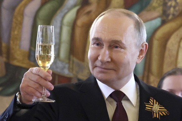 Russian President Vladimir Putin toasts as he attends an official reception, to mark the 79th anniversary of the end of World War II, at the Kremlin in Moscow, Russia, Thursday, May 9, 2024. (Mikhail  ...