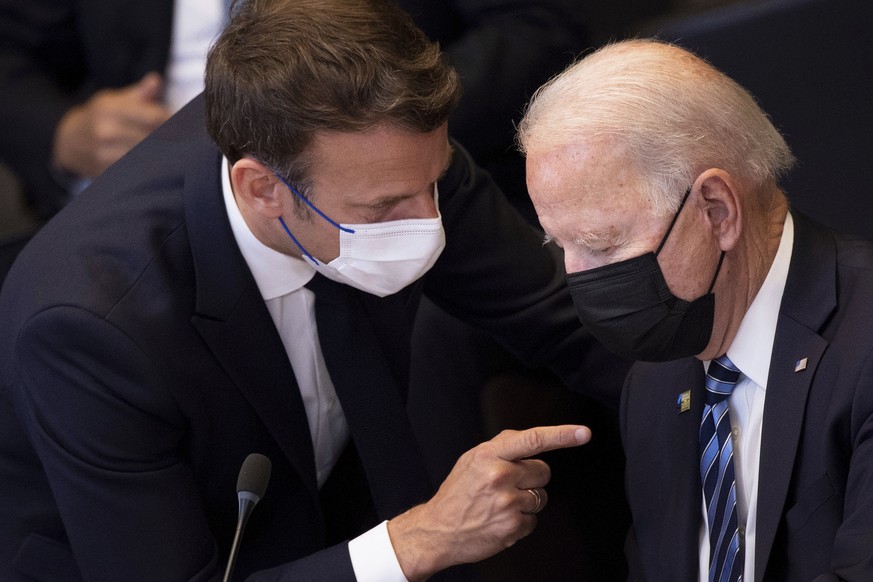 U.S. President Joe Biden, right, speaks with French President Emmanuel Macron during a plenary session during a NATO summit at NATO headquarters in Brussels, Monday, June 14, 2021. U.S. President Joe  ...