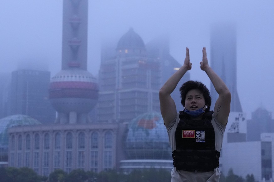A resident exercises along the bund as day breaks, Wednesday, June 1, 2022, in Shanghai. Shanghai authorities say they will take major steps Wednesday toward reopening China&#039;s largest city after  ...