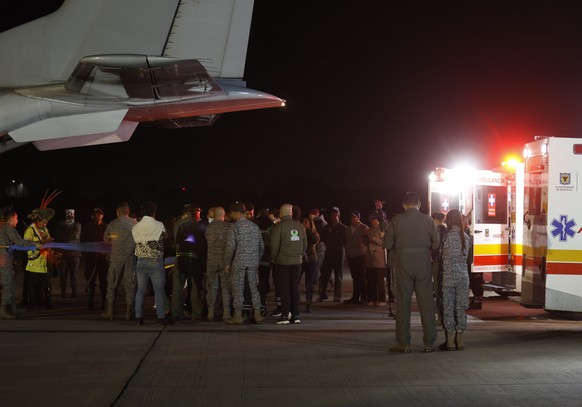epa10682885 People and military personnel gather during an unload operation of four children who were missing after a plane crash, at the CATAM Military Airport in Bogota, Colombia, 10 June 2023, befo ...