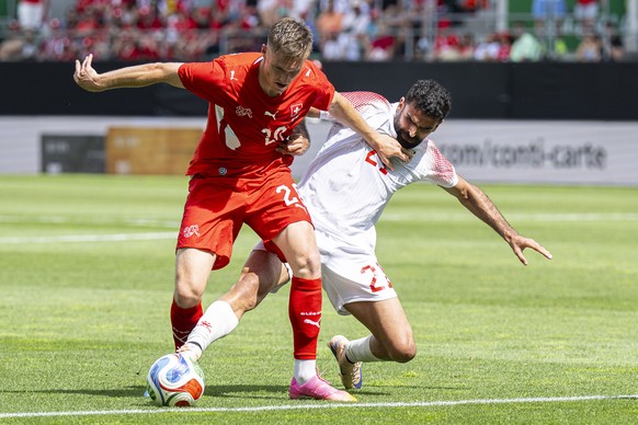 epa13006569 Switzerland's Michel Aebischer, left, fights for the ball with Jordan's Nizar Al-Rashdan during the international friendly soccer match between Switzerland and Jordan, at the kyb ...