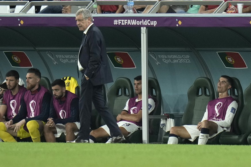 Portugal&#039;s Cristiano Ronaldo, right, sits on the bench during the World Cup group H soccer match between South Korea and Portugal, at the Education City Stadium in Al Rayyan , Qatar, Friday, Dec. ...