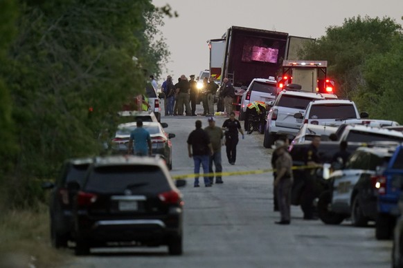 Police and other first responders work the scene where officials say dozens of people have been found dead and multiple others were taken to hospitals with heat-related illnesses after a semitrailer c ...