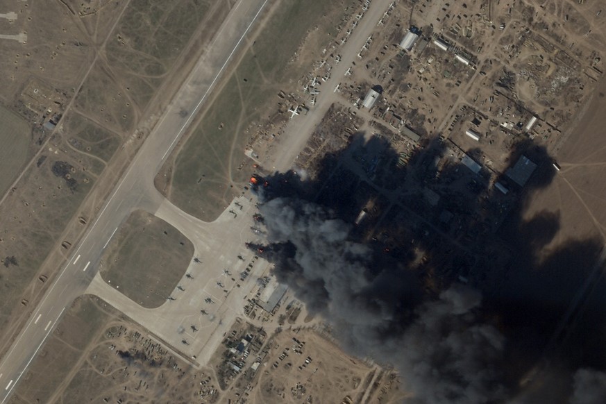 In this satellite picture provided by Planet Labs PBC, fire and smoke is seen at Kherson International Airport and Air Base in Kherson, Ukraine, Tuesday, March 15, 2022. A suspected Ukrainian strike o ...