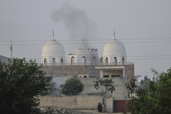 Local residents stand outside a mosque of an Islamic seminary partially damaged by a suspected Indian missile attack, outskirts of Bahawalpur, Pakistan, Wednesday, May 7, 2025. (AP Photo/Asim Tanveer) ...