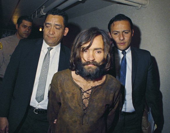 FILE - In this 1969 file photo, Charles Manson is escorted to his arraignment on conspiracy-murder charges in connection with the Sharon Tate murder case. Authorities say Manson, cult leader and maste ...