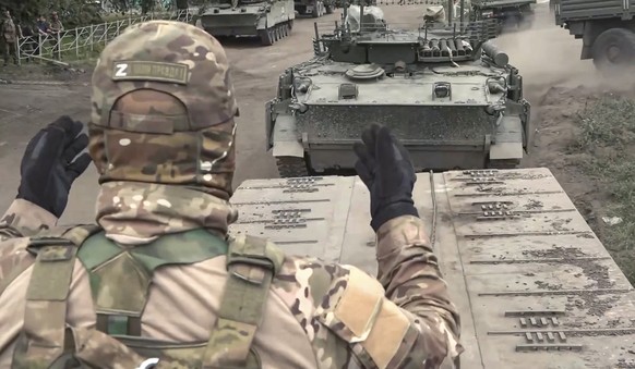 epa11547738 A still image taken from a handout video provided by the Russian Defence Ministry on 13 August 2024 shows Russian military armored vehicles being deployed during the delivery of additional ...