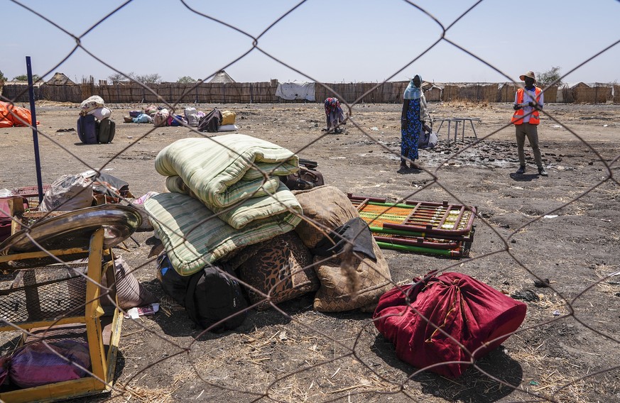 The belongings of people who crossed the border from Sudan sit in a yard at the Joda border crossing in South Sudan Tuesday, May 16, 2023. Tens of thousands of South Sudanese are flocking home from ne ...