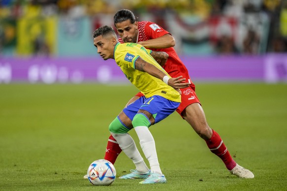 Brazil&#039;s Raphinha , left, fights for the ball with Switzerland&#039;s Ricardo Rodriguez during the World Cup group G soccer match between Brazil and Switzerland, at the Stadium 974 in Doha, Qatar ...