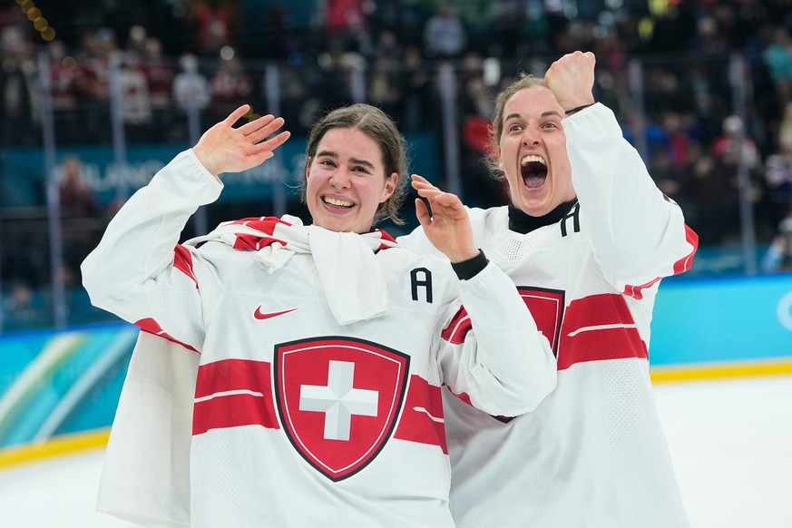 Switzerland's Alina Muller (25), left, celebrates with Switzerland's Kaleigh Quennec (8) after a women's ice hockey bronze medal game between Switzerland and Sweden at the 2026 Winter O ...