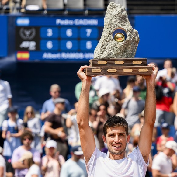 The winner Pedro Cachin of Argentina celebrates with the trophy after the victory against Albert Ramos-Vinolas of Spain during their final game at the Swiss Open tennis tournament in Gstaad, Switzerla ...