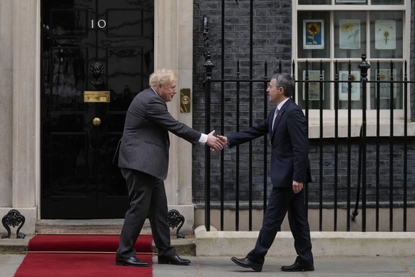 Britain&#039;s Prime Minister Boris Johnson, left, greets the President of Switzerland Ignazio Cassis on the doorstep of 10 Downing Street ahead of a meeting inside, in London, Thursday, April 28, 202 ...