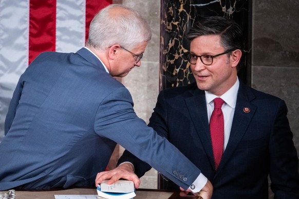 UNITED STATES - OCTOBER 25: Speaker-designate Rep. Mike Johnson, R-La., right, talks with Speaker pro tempore Patrick McHenry, R-N.C., on the House floor of the U.S. Capitol before Johnson was elected ...
