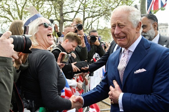 LONDON, ENGLAND - MAY 05: King Charles III meets well-wishers during a walkabout on the Mall outside Buckingham Palace ahead of his and Camilla, Queen Consort's coronationon May 5, 2023 in London ...