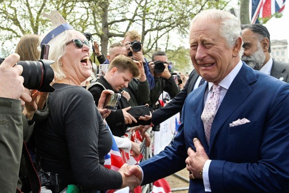 LONDON, ENGLAND - MAY 05: King Charles III meets well-wishers during a walkabout on the Mall outside Buckingham Palace ahead of his and Camilla, Queen Consort&#039;s coronationon May 5, 2023 in London ...