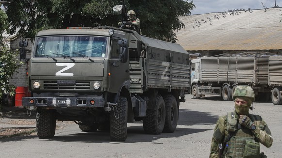 epa10072115 A picture taken during a visit to Melitopol organized by the Russian military shows Russian servicemen at a grain storage facility in Melitopol, Zaporizhia region, southeastern Ukraine, 14 ...