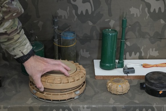 A Cypriot National Guardsman handles an inert landmine that is part of a display of inert rockets, artillery shells and other munitions as part of a training course of Ukrainian personnel in the dispo ...