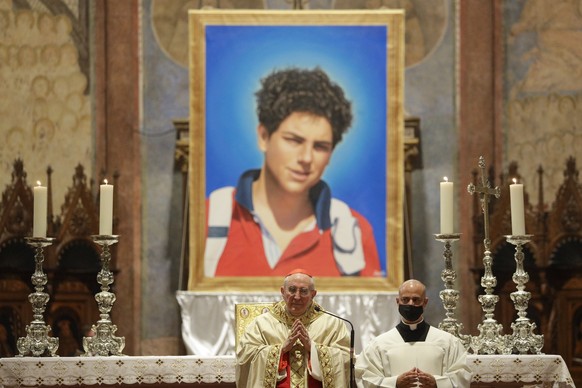 FILE - An image of 15-year-old Carlo Acutis, an Italian boy who died in 2006 of leukemia, is seen during his beatification ceremony celebrated by Cardinal Agostino Vallini, center, in the St. Francis  ...