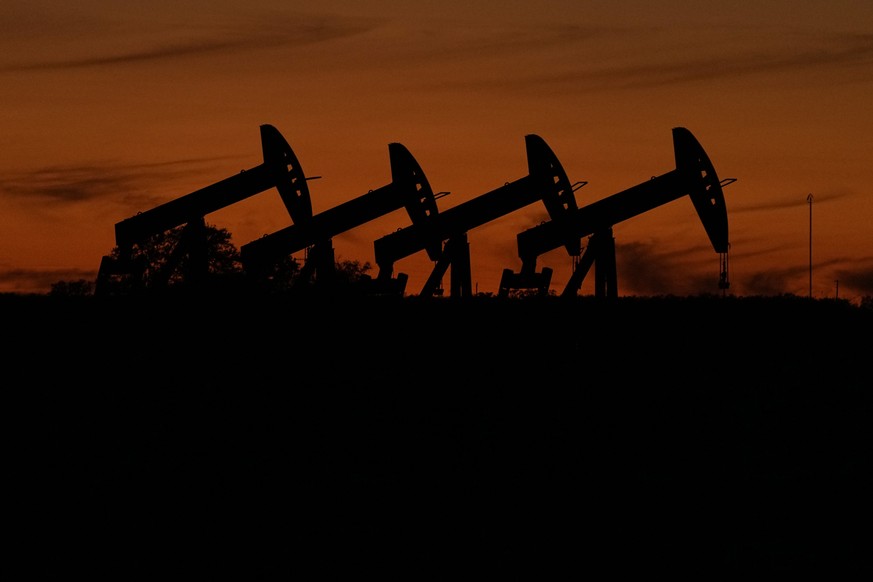 Oil pump jacks operate at dusk near Barnes City, Texas, Wednesday, Nov. 1, 2023. U.S. regulators are scheduled to decide Wednesday, March 6, 2024, on a rule that would require companies to disclose th ...
