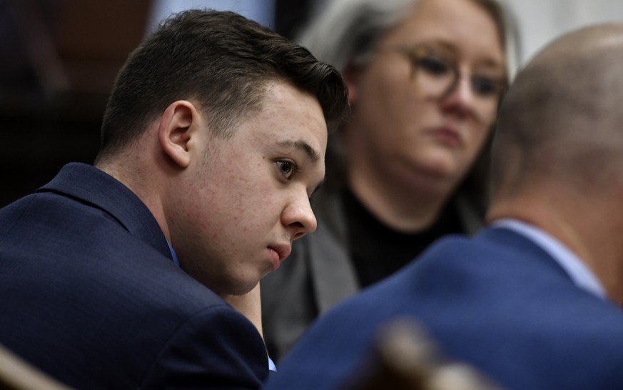 Kyle Rittenhouse, left, listens as his attorney Mark Richards gives his closing argument during Rittenhouse's trial at the Kenosha County Courthouse in Kenosha, Wis., on Monday, Nov. 15, 2021. Ri ...