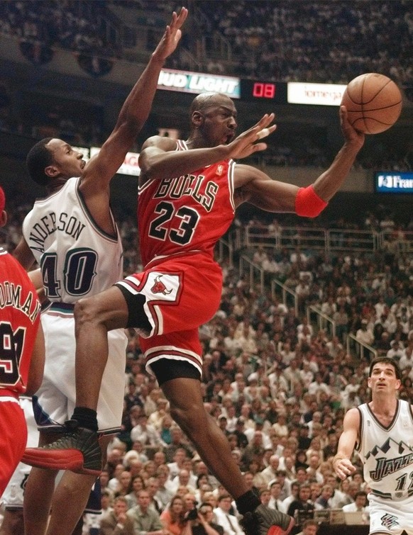 The Chicago Bulls&#039; Michael Jordan passes off in front of the Utah Jazz&#039; Shandon Anderson during the first quarter of Game 5 of the NBA Finals Wednesday, June 11, 1997, in Salt Lake City. (AP ...