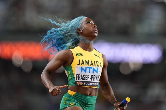 FILE - Shelly-Ann Fraser-Pryce, of Jamaica anchors her team to win a Women&#039;s 4x100-meters relay heat during the World Athletics Championships in Budapest, Hungary, Friday, Aug. 25, 2023. (AP Phot ...