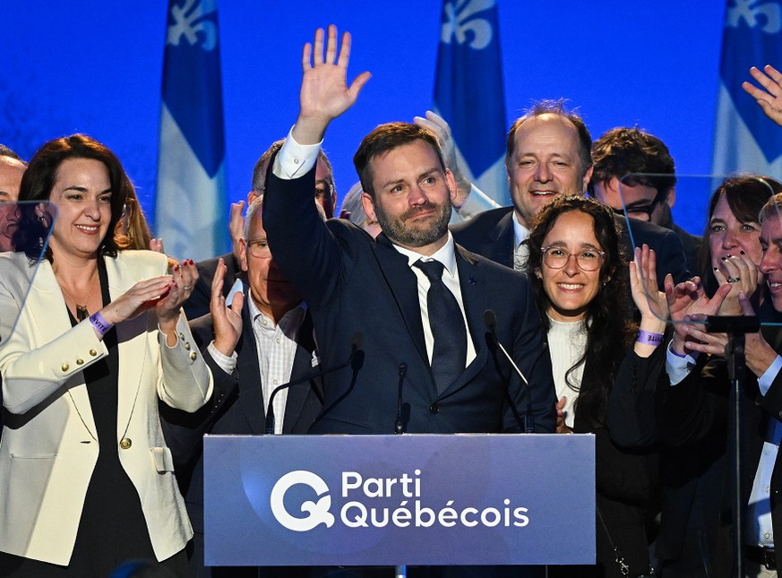 Parti Quebecois Leader Paul St-Pierre Plamondon, center, waves to supporters after winning the provincial election in Montreal, Quebec on Monday, Oct. 5, 2026. (Graham Hughes/The Canadian Press via AP ...