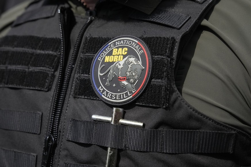 A police officer member of the local BAC (Brigade anti-criminalit�) during French President Emmanuel Macron's visit focusing on security and the fight against drug trafficking, Tuesday, March 19, ...