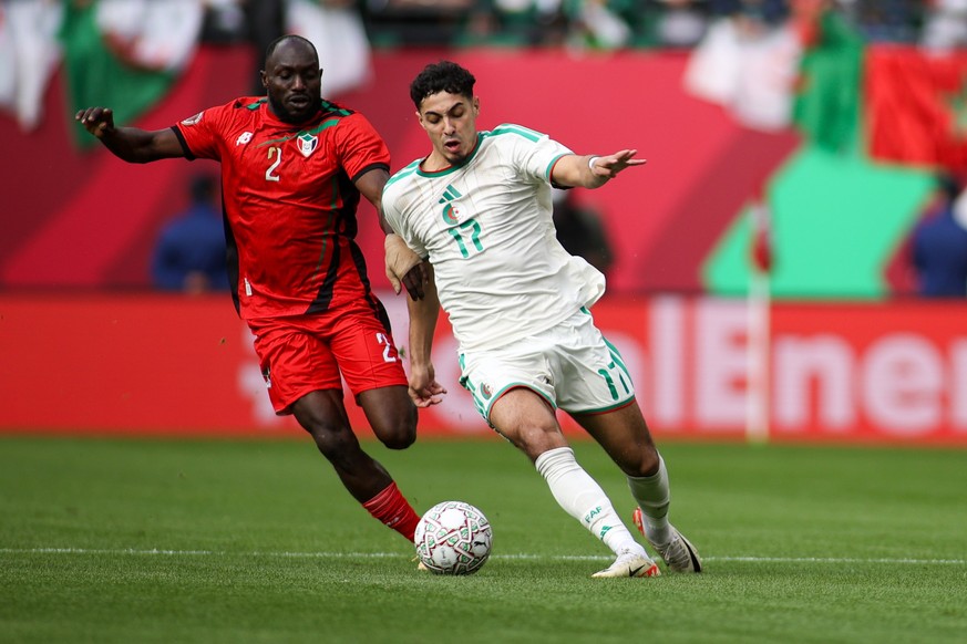 Rabat, Morocco - December 24: Sudan's Abuaagla Abdalla Mohamed and Algeria's Fares Chaibi battling for the ball during the Africa Cup Of Nations Group E match between Algeria and Sudan at Mo ...