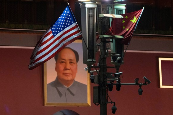 A U.S. flag is flown next to the Chinese flag near a portrait of Mao Zedong on Tiananmen Gate as U.S. President Donald Trump arrives in Beijing, Wednesday, May 13, 2026. (AP Photo/Ng Han Guan)
China T ...