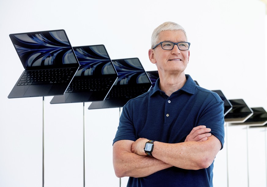 FILE - Apple CEO Tim Cook stands in front of a display of new Apple MacBook Air computers with M2 processors, Monday, June 6, 2022, following the keynote presentation of Apple&#039;s World Wide Develo ...