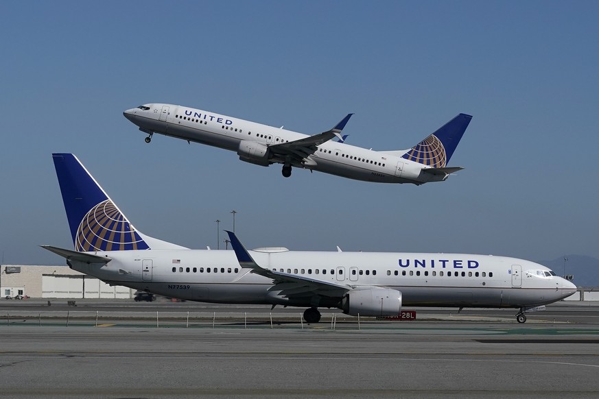 FILE - In this Oct. 15, 2020, file photo, a United Airlines airplane takes off over a plane on the runway at San Francisco International Airport in San Francisco. United Airlines says it will train 5, ...