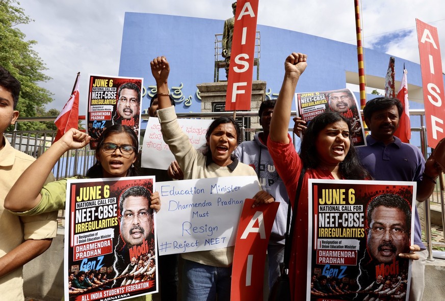 epa13019952 Members of the All India Students Federation (AISF) hold placards and shout slogans during a protest against the alleged National Eligibility cum Entrance Test (NEET) paper leak in Bangalo ...