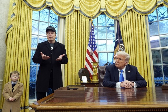 President Donald Trump listens as Elon Musk, joined by his son X � A-Xii, speaks in the Oval Office at the White House, Tuesday, Feb. 11, 2025, in Washington. (Photo/Alex Brandon)