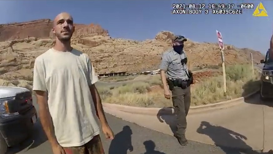 FILE - This Aug. 12, 2021, file photo from video provided by the Moab, Utah, Police Department shows Brian Laundrie talking to a police officer after police pulled over the van he was traveling in wit ...